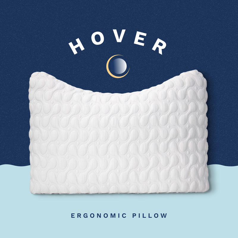 Hover Ergonomic Pillow. White plush quilted pillow with a crescent shape contour to allow for pillow to cradle the neck and shoulders.