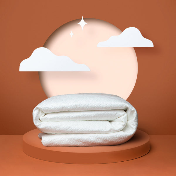 White mattress protector folded up in front of an orange background (No Script)