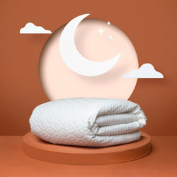 Photo of a white mattress protector folded up in front of an orange background.