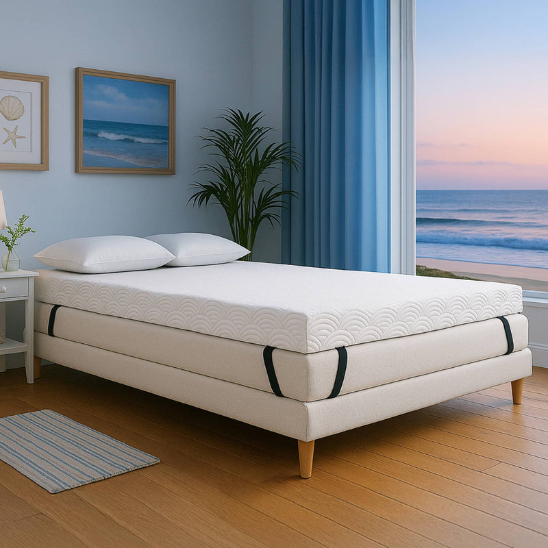 Mattress on a bed in a room with a large window view of the ocean.