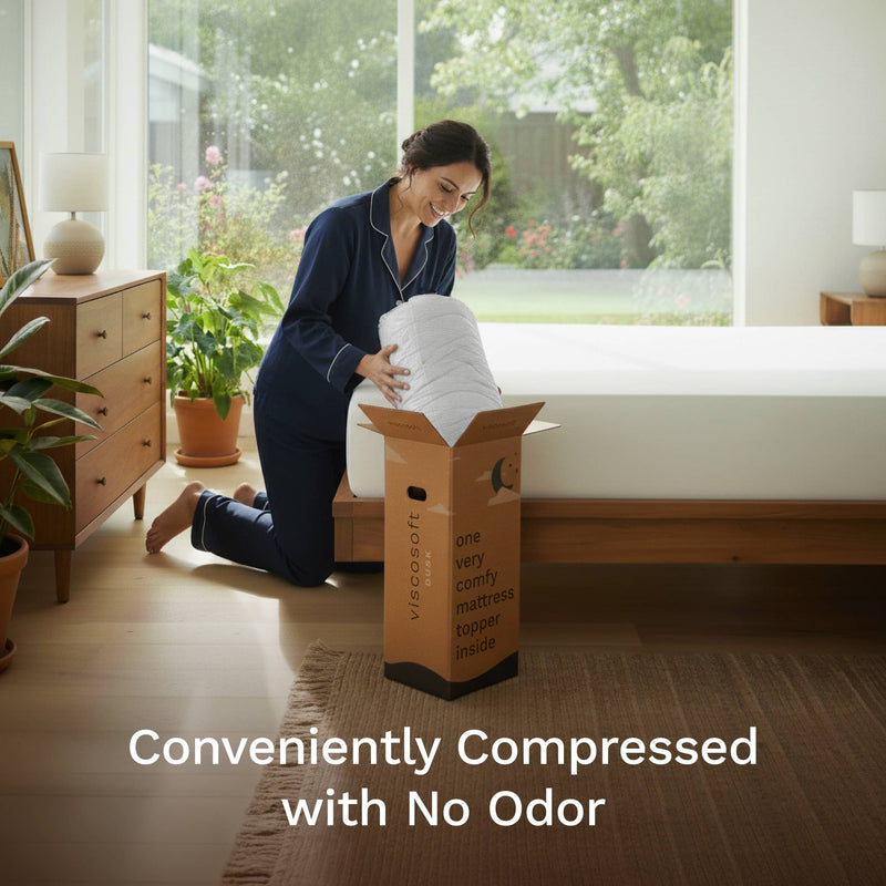 Woman unboxing a compressed mattress topper from a box in a bedroom.