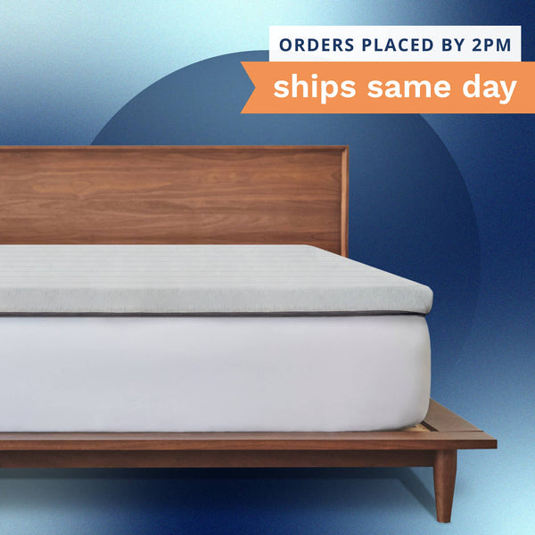 Orders placed by 2pm ships same day. A thick gray mattress topper sitting on top of a bed. (No Script)