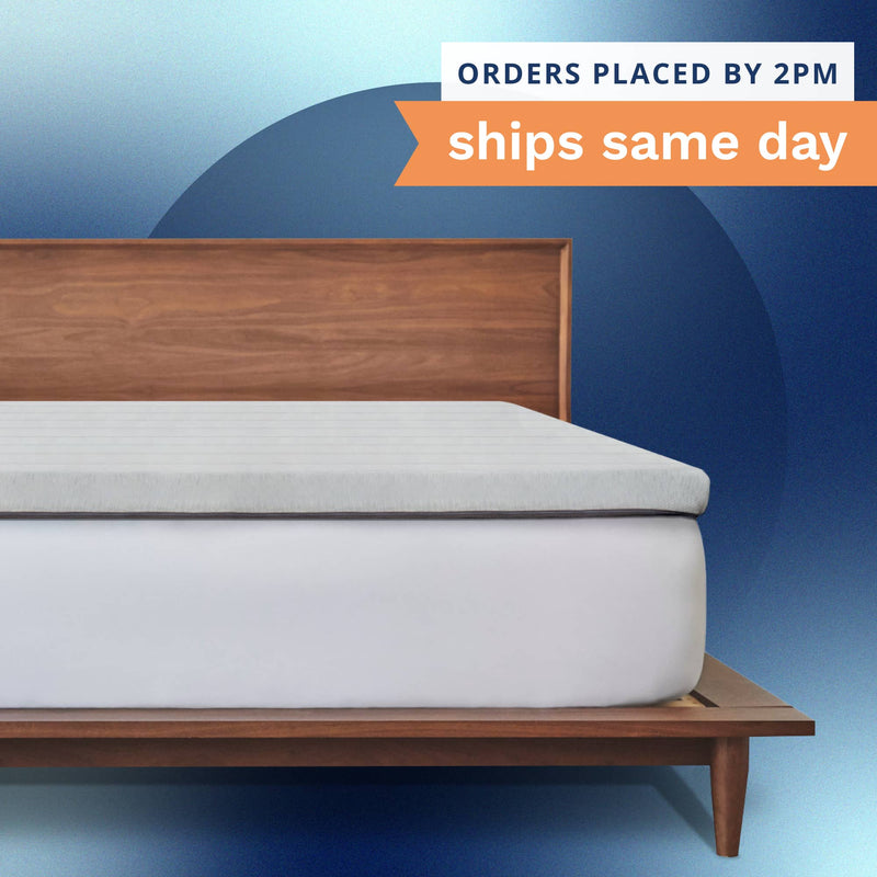 Orders placed by 2pm ships same day. A thick gray mattress topper sitting on top of a bed.