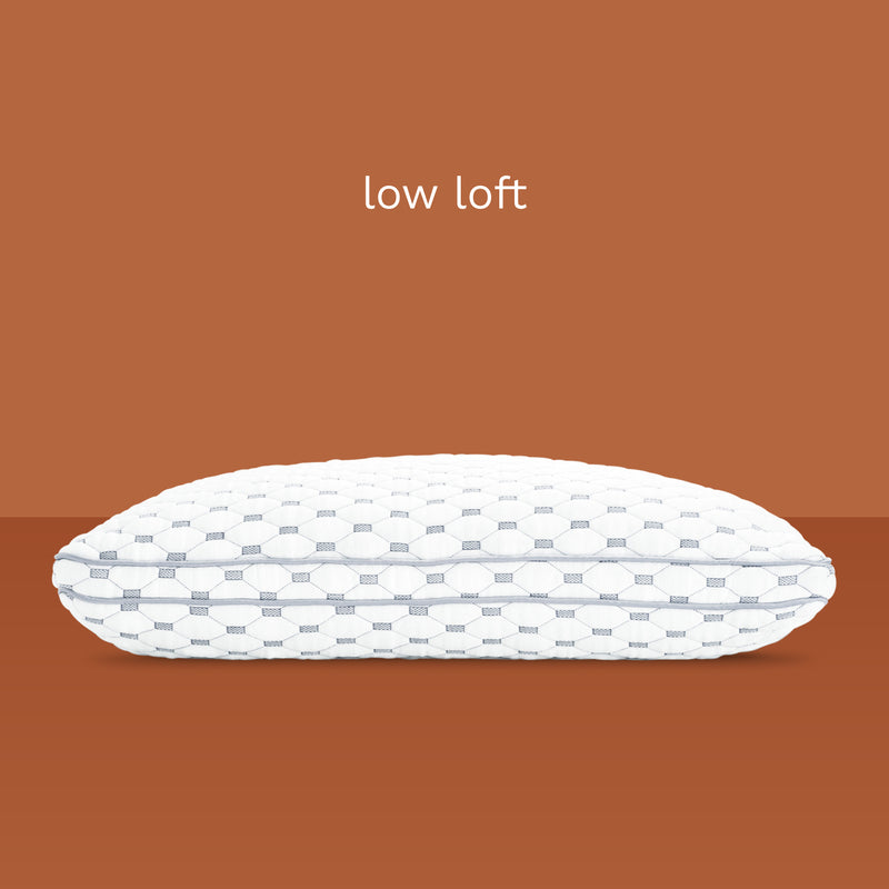 Low loft: Side view of thin, memory foam pillow. Unique fabric design of diamonds and rectangles.