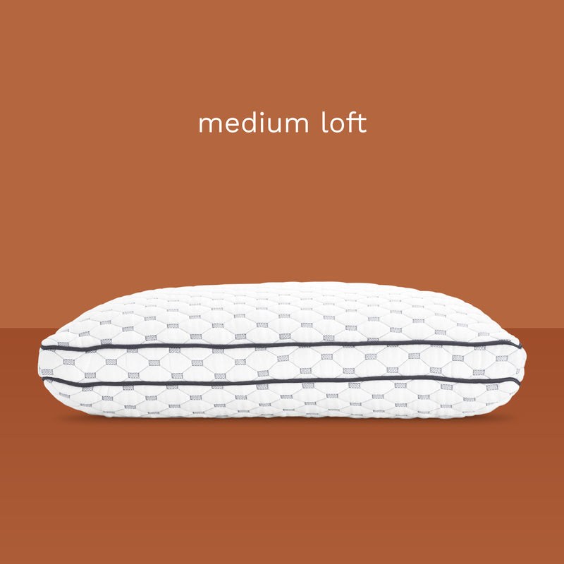 Medium Loft: Side view of medium thickness, memory foam pillow. Unique fabric design of diamonds and rectangles.