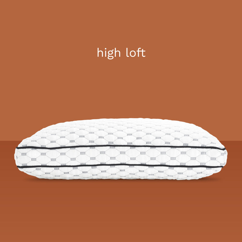 High loft: Side view of thick, memory foam pillow. Unique fabric design of diamonds and rectangles.