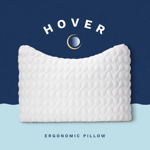 Hover Ergonomic Pillow. White plush quilted pillow with a crescent shape contour to allow for pillow to cradle the neck and shoulders. (No Script)