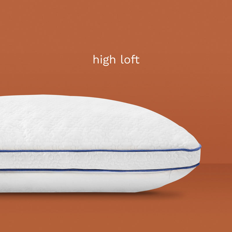 High Loft: White pillow with dark blue piping.