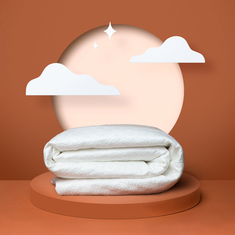 White mattress protector folded up in front of an orange background