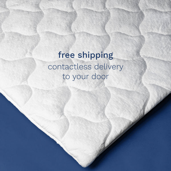 Free shipping. Contactless delivery to your door. Top down photo of the corner of a white pillow top mattress pad.  (No Script, Alternate View)