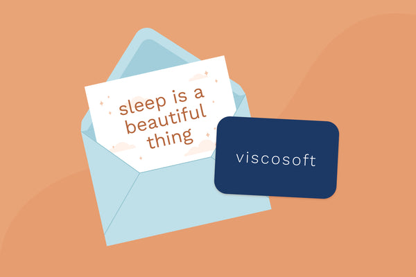 Illustration of a ViscoSoft gift card on top of an envelope and a card that says "Sleep is a beautiful thing" (No Script, Alternate View)